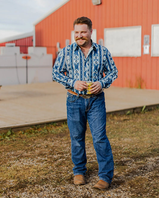 Cole Martin wearing Checotah shirt from wrangler and cinch grant jeans with ariat rambler boots