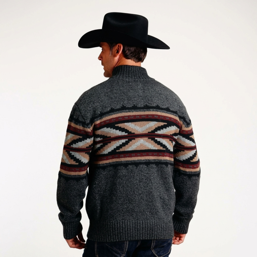 Man wearing a patterned sweater and cowboy hat on a white background