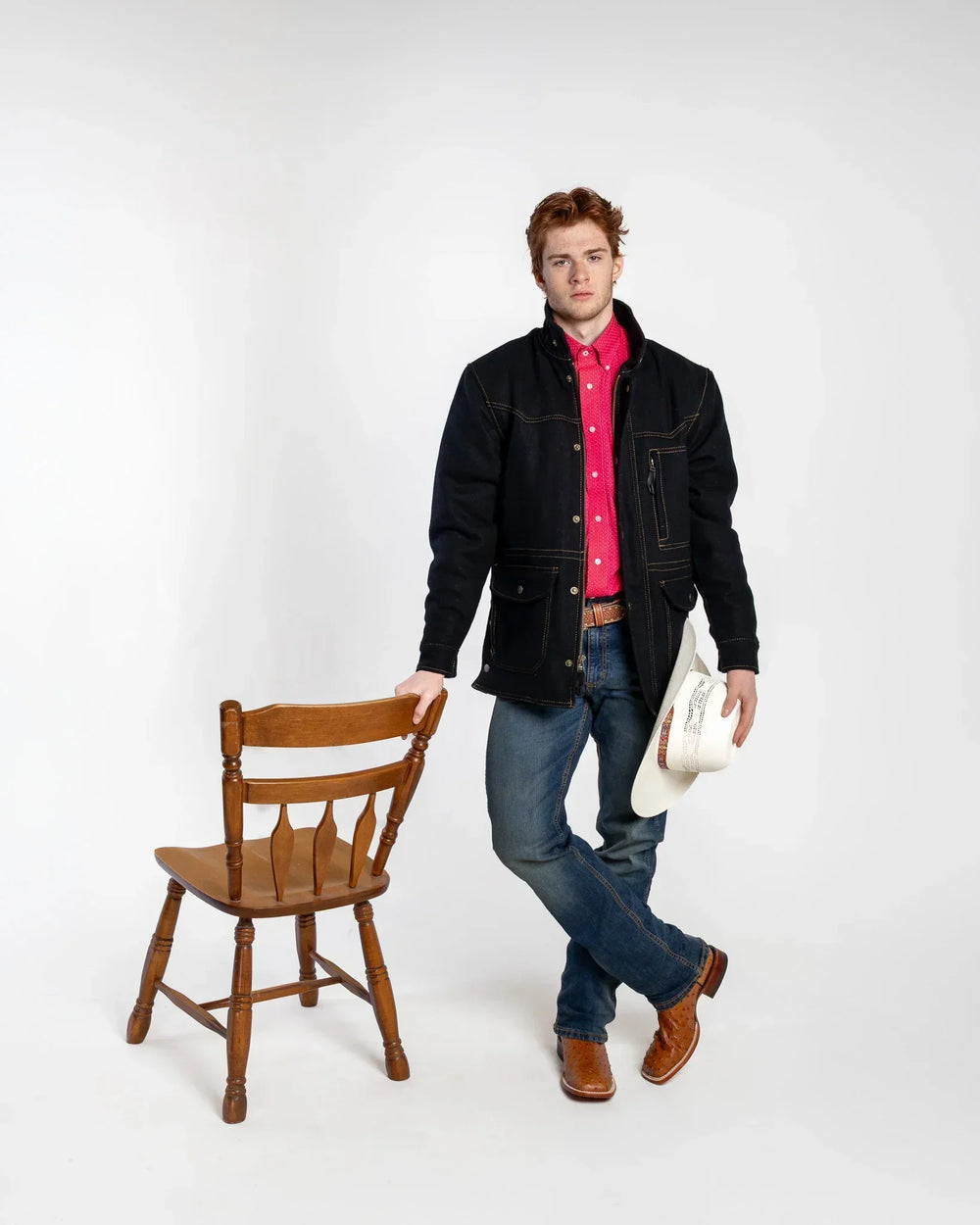 Krisjanis styled in cowboy hat, denim jacket, and boots