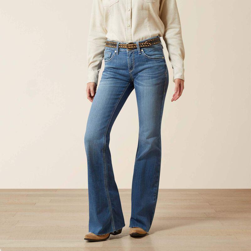 Woman wearing Ariat Perfect Rise Andrea Flare Jean in medium wash, flare leg and studded belt, front view.