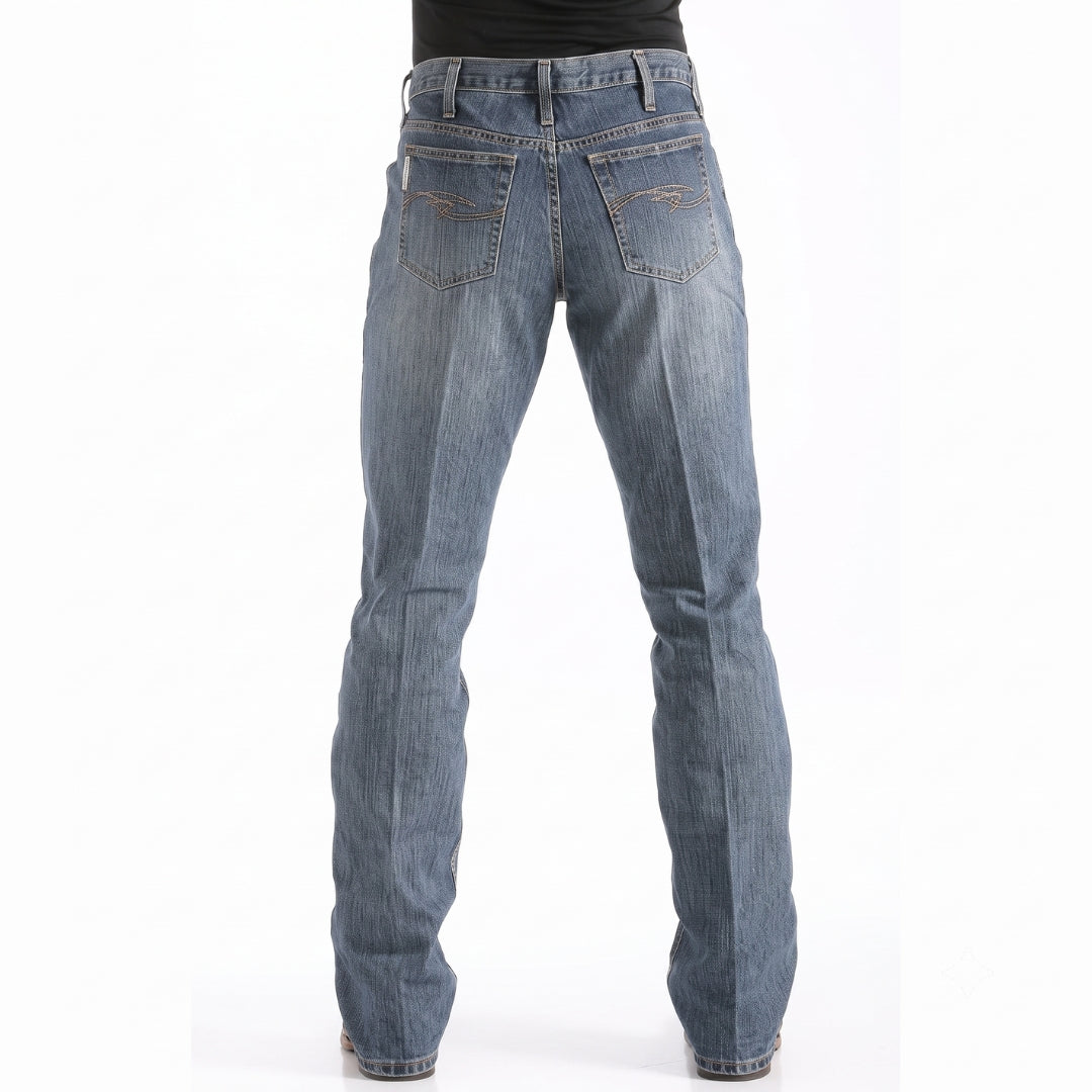 Cinch Dooley relaxed fit bootcut jeans, medium wash denim back view on model.