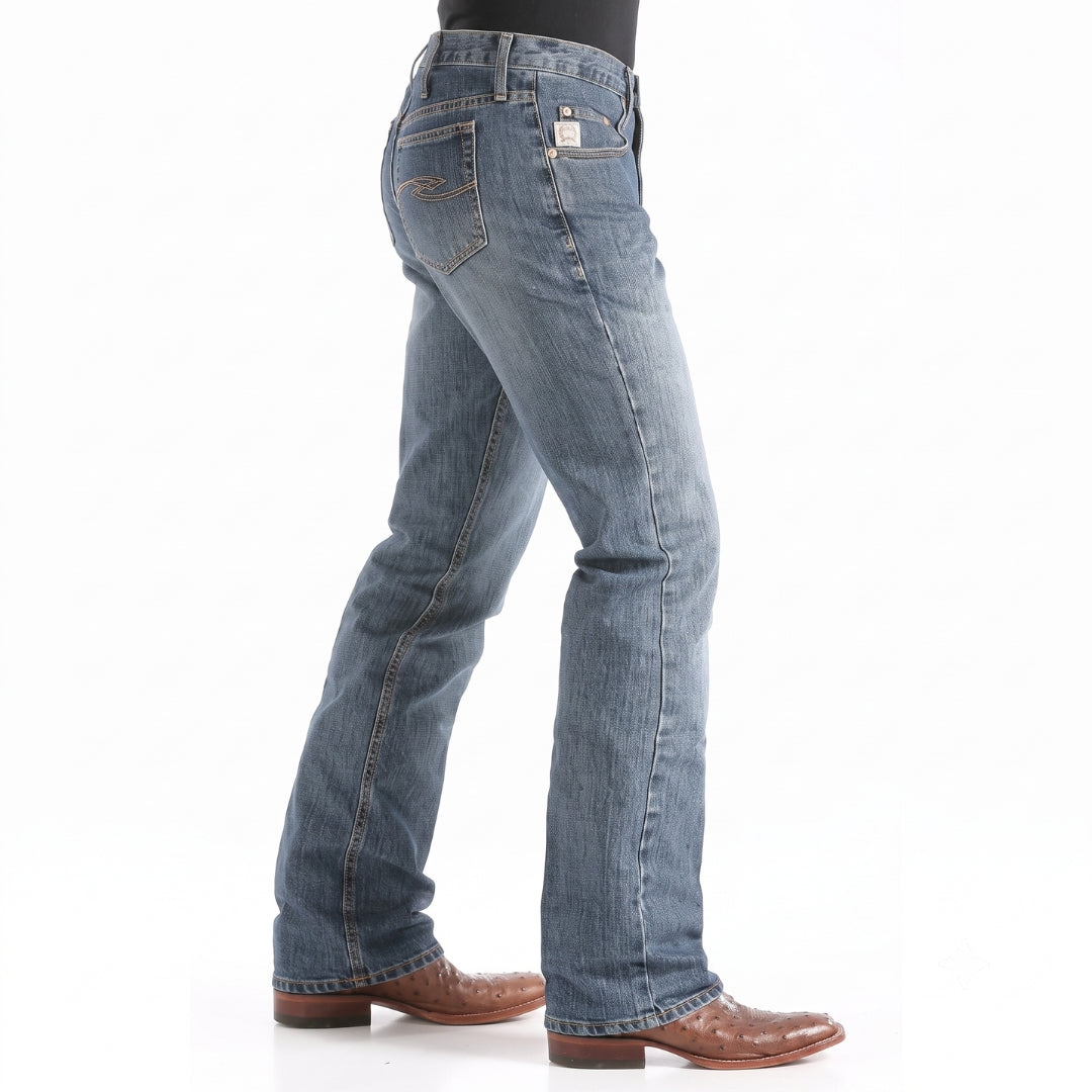 Cinch Dooley relaxed fit bootcut jeans, medium wash denim side view on model.