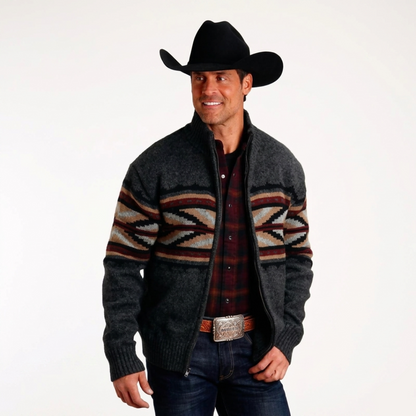 Man wearing a patterned cardigan, plaid shirt, and cowboy hat on a white background