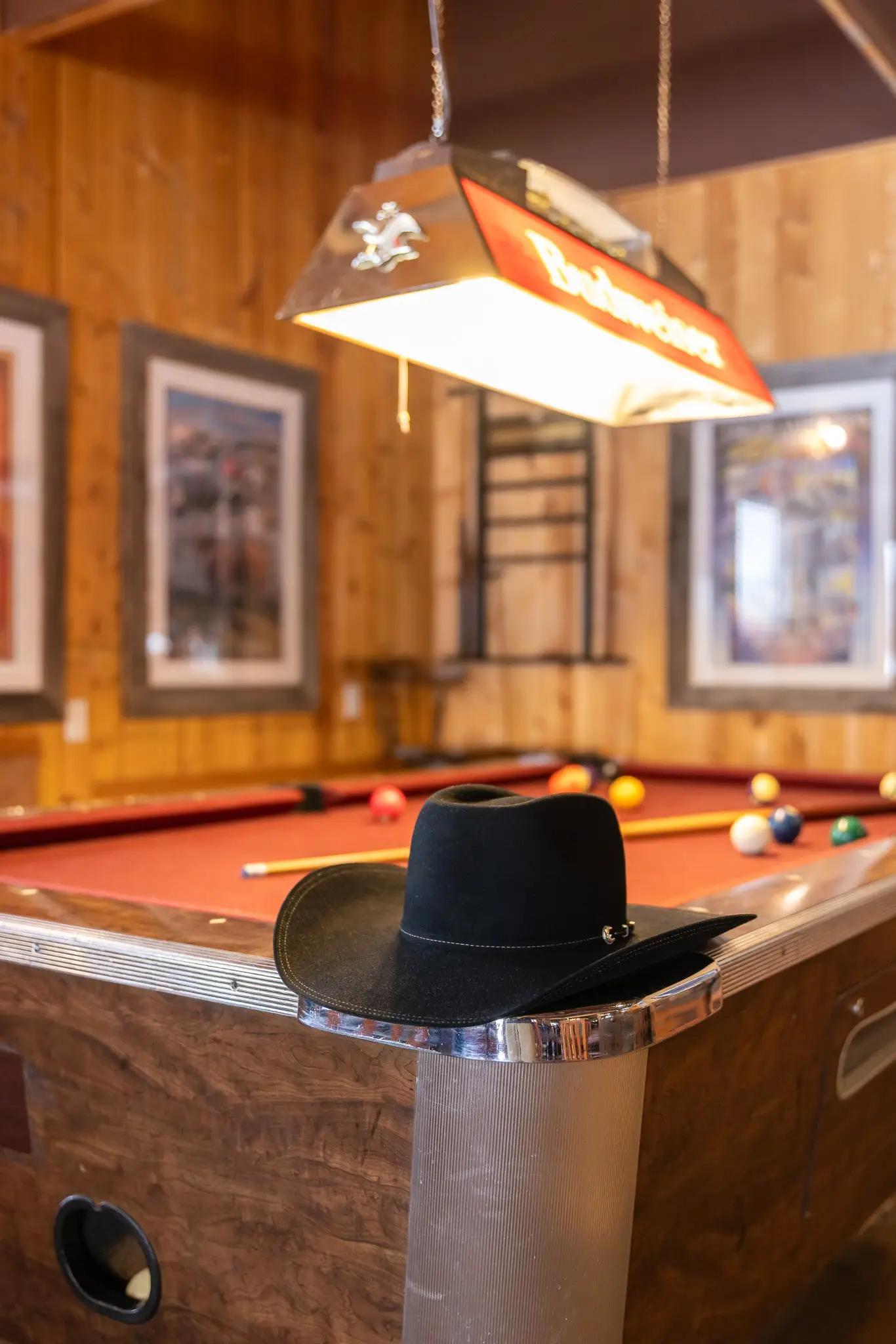 Stetson Trilogy 6X cowboy hat in black fur felt, pool table lifestyle view.